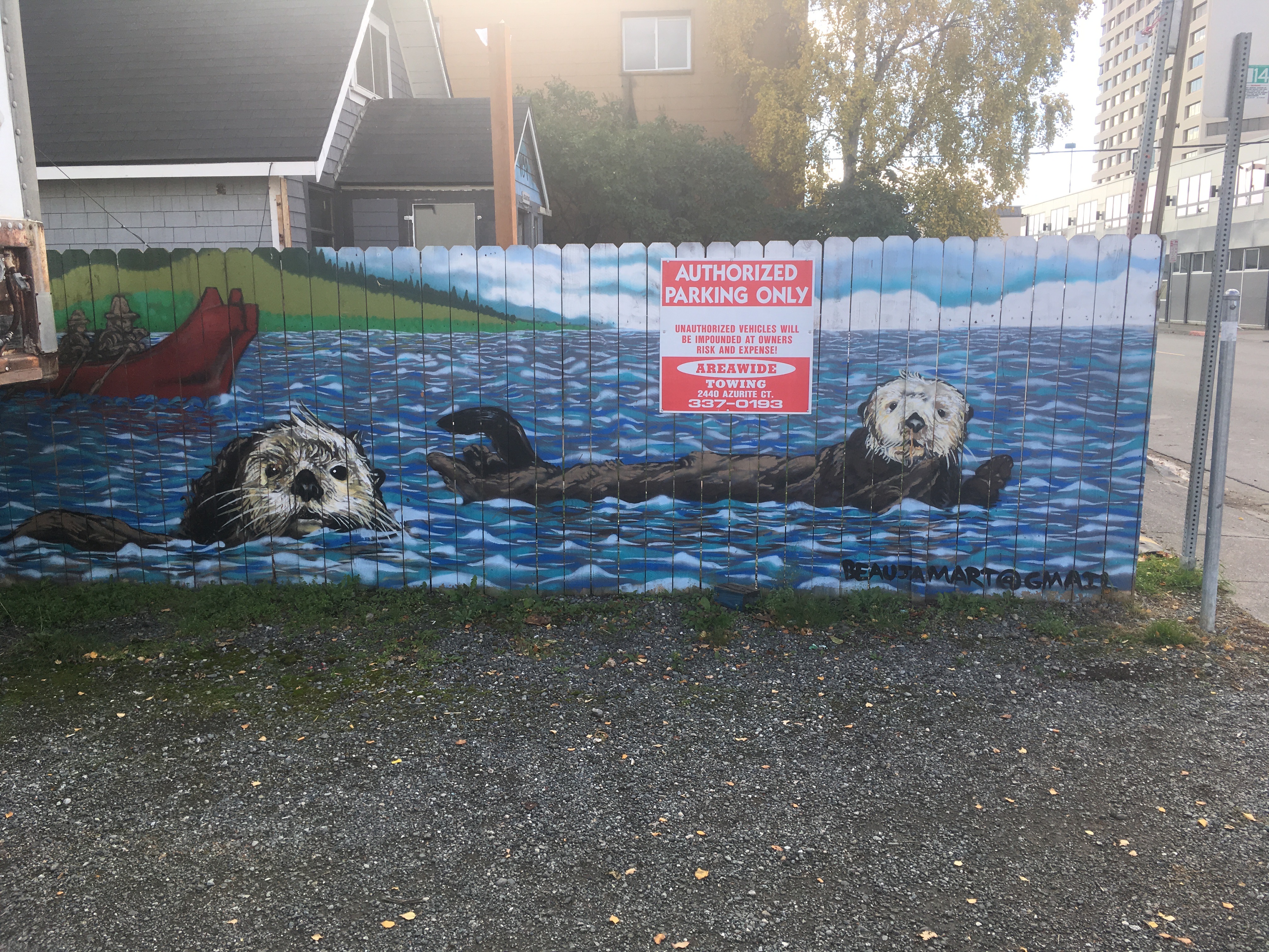 Getting ideas for painting my fence back home... Otters on fence in Anchorage